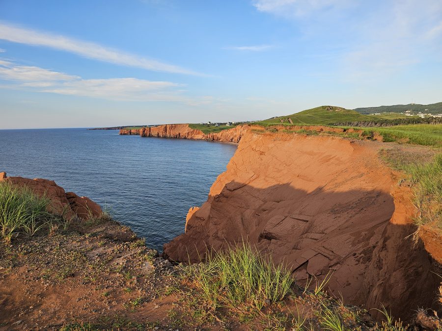 Red sandstone cliffs at golden hour on the Prince Edward Island coast