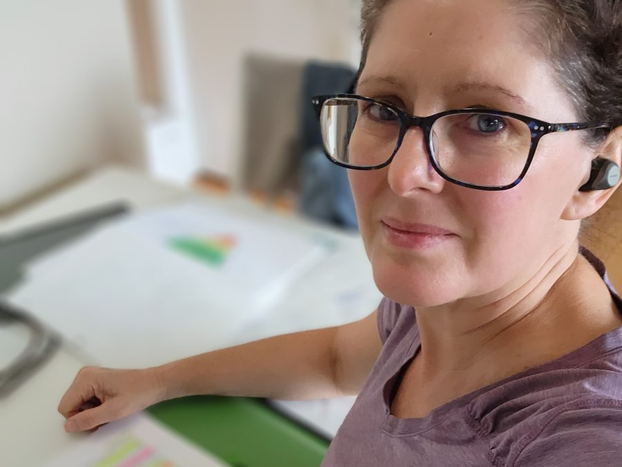 Kay at her desk with highlighted study notes